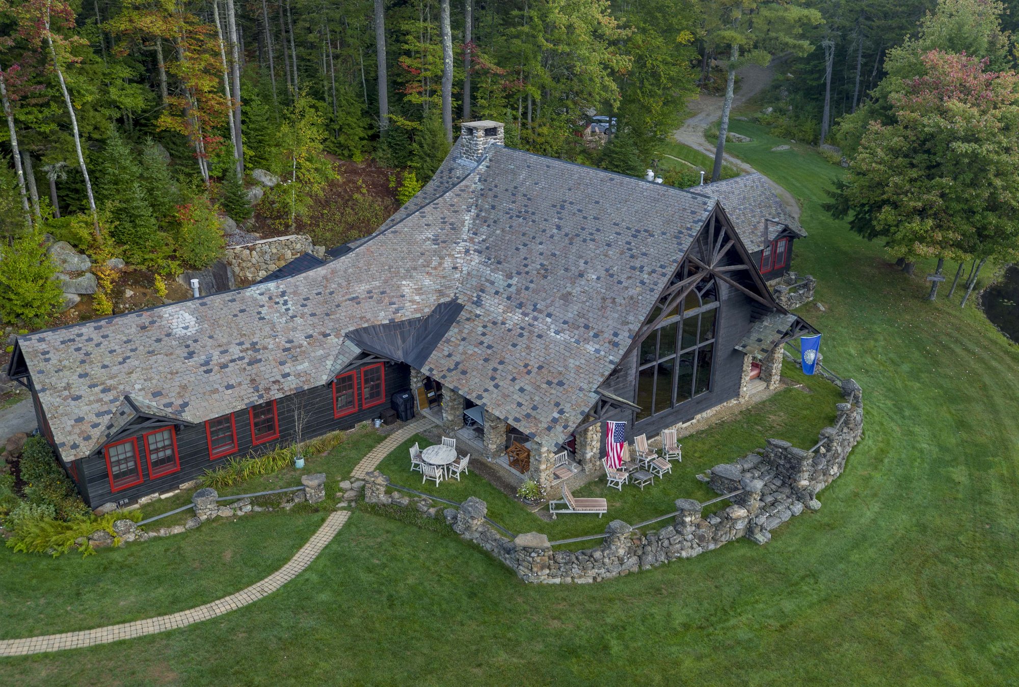Lakefalls Lodge from above, its lawn running to the pond