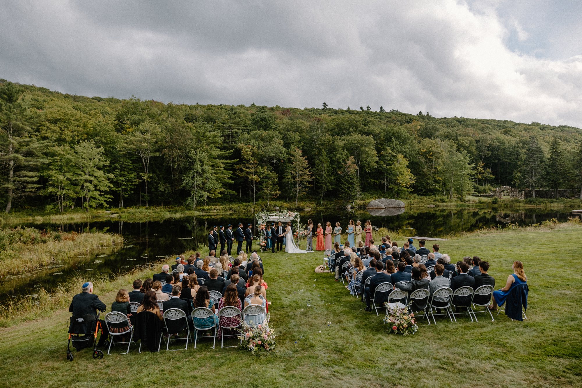 Guests seated on the Lodge Lawn by the water
